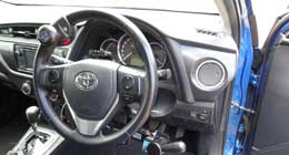 Interior view of a Toyota vehicle highlighting the steering wheel and dashboard.